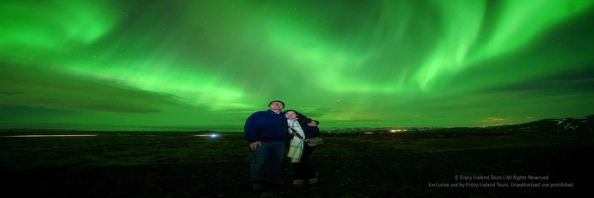 Couple embracing under the Northern Lights in Iceland